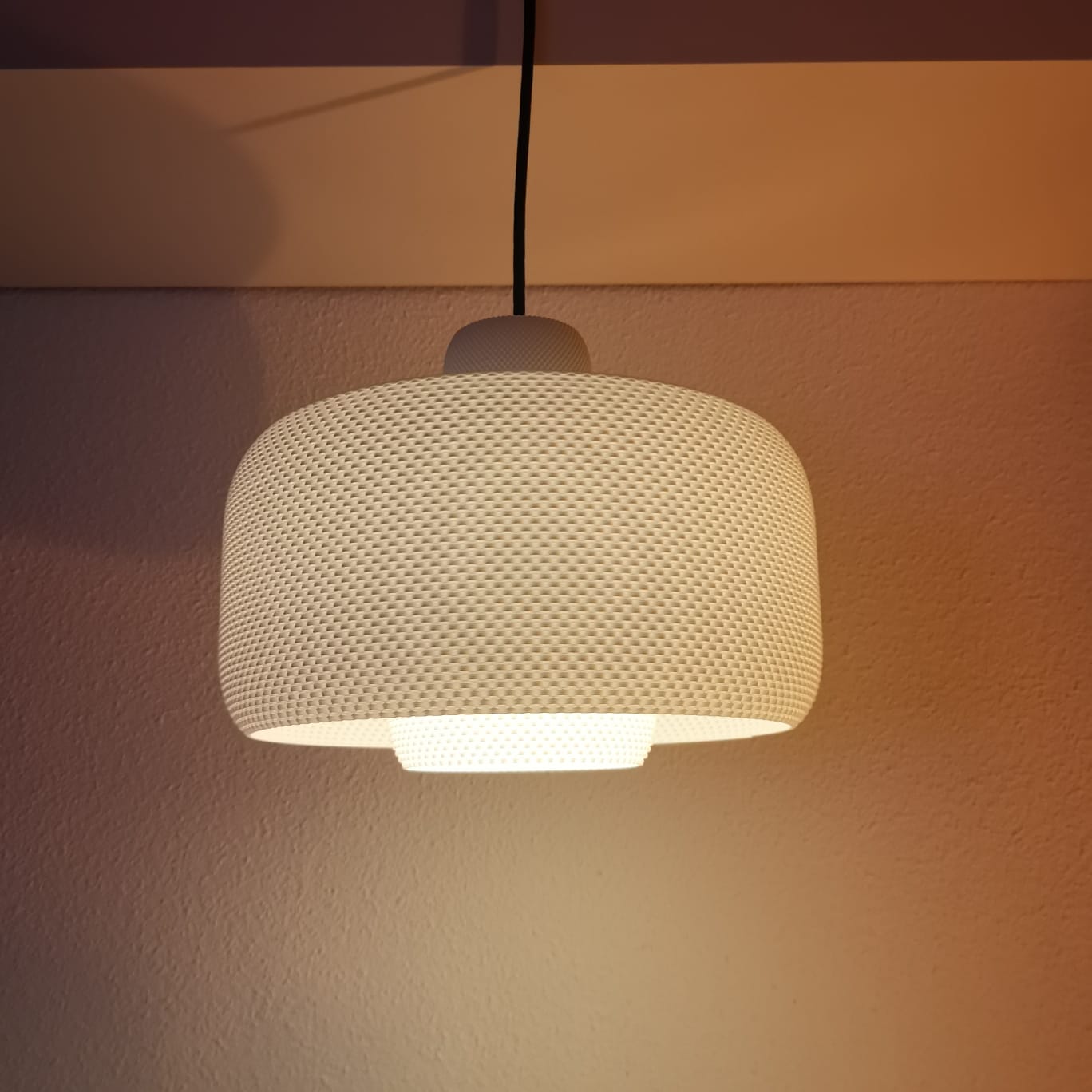 Textured pendant light fixture on a neutral background