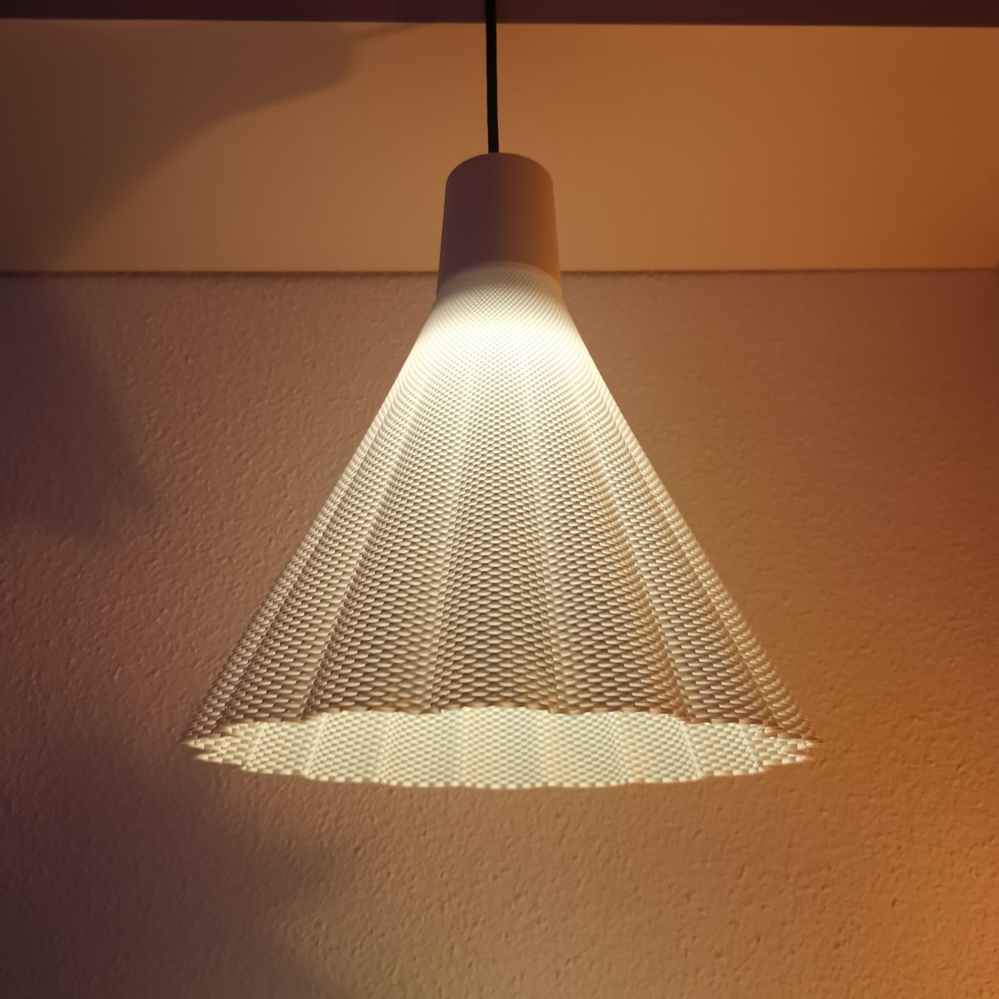 Modern pendant light with a textured shade on a neutral background