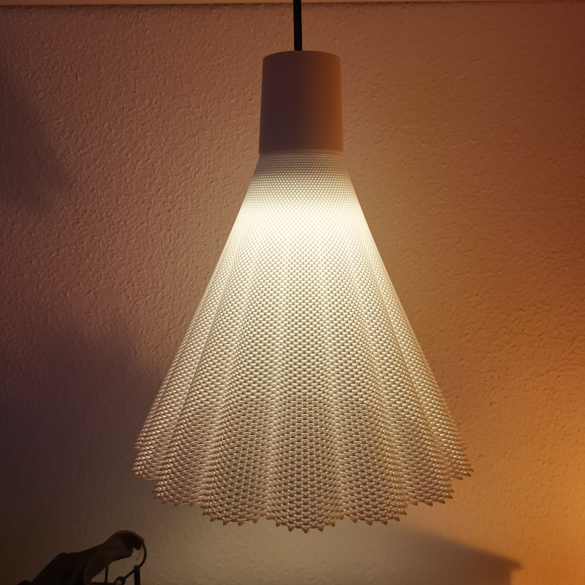 Pendant lamp with textured design against a plain background