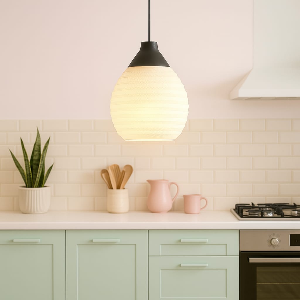 Modern kitchen with pendant light, countertop items, and green cabinets.