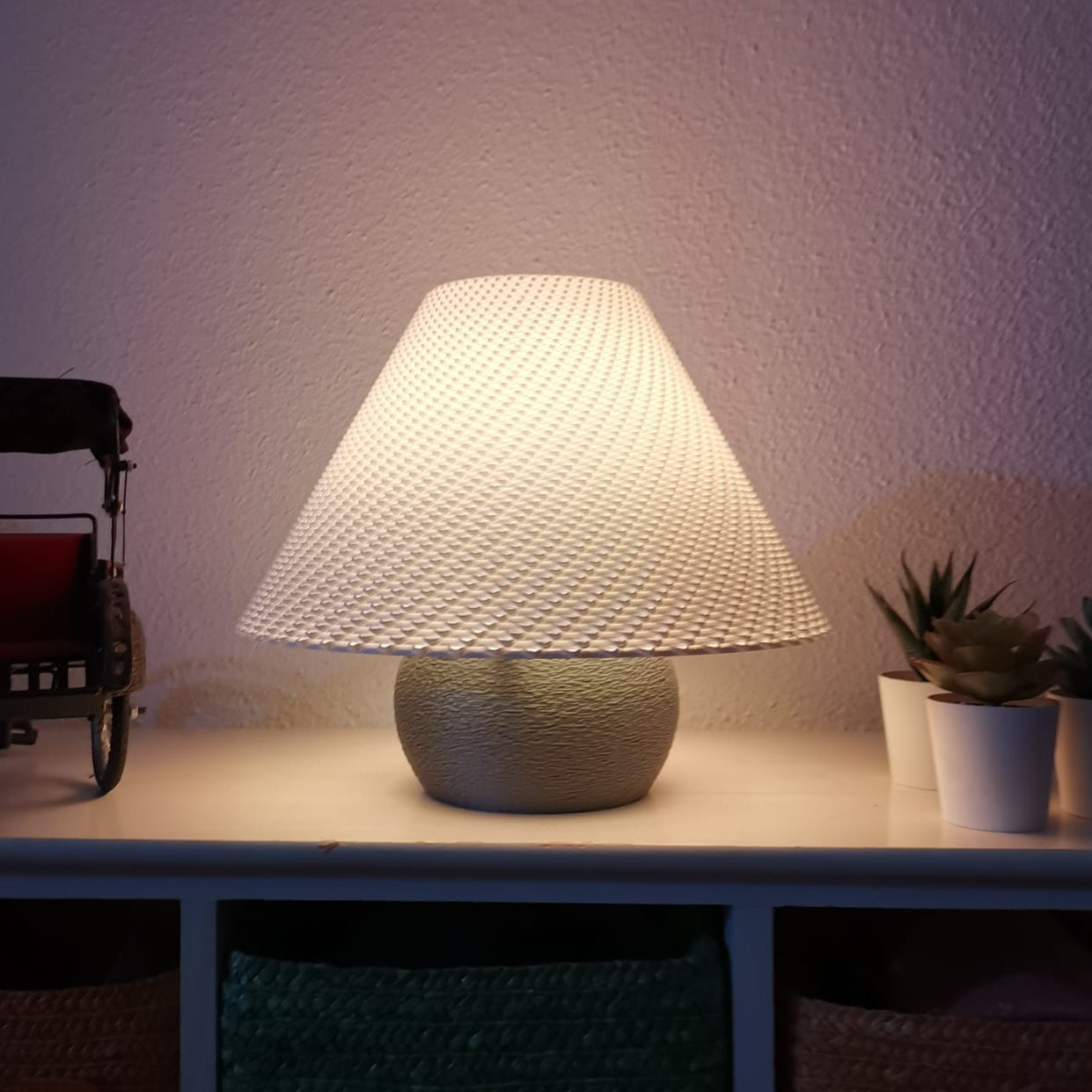 Table lamp with textured shade on a surface with a blurred background
