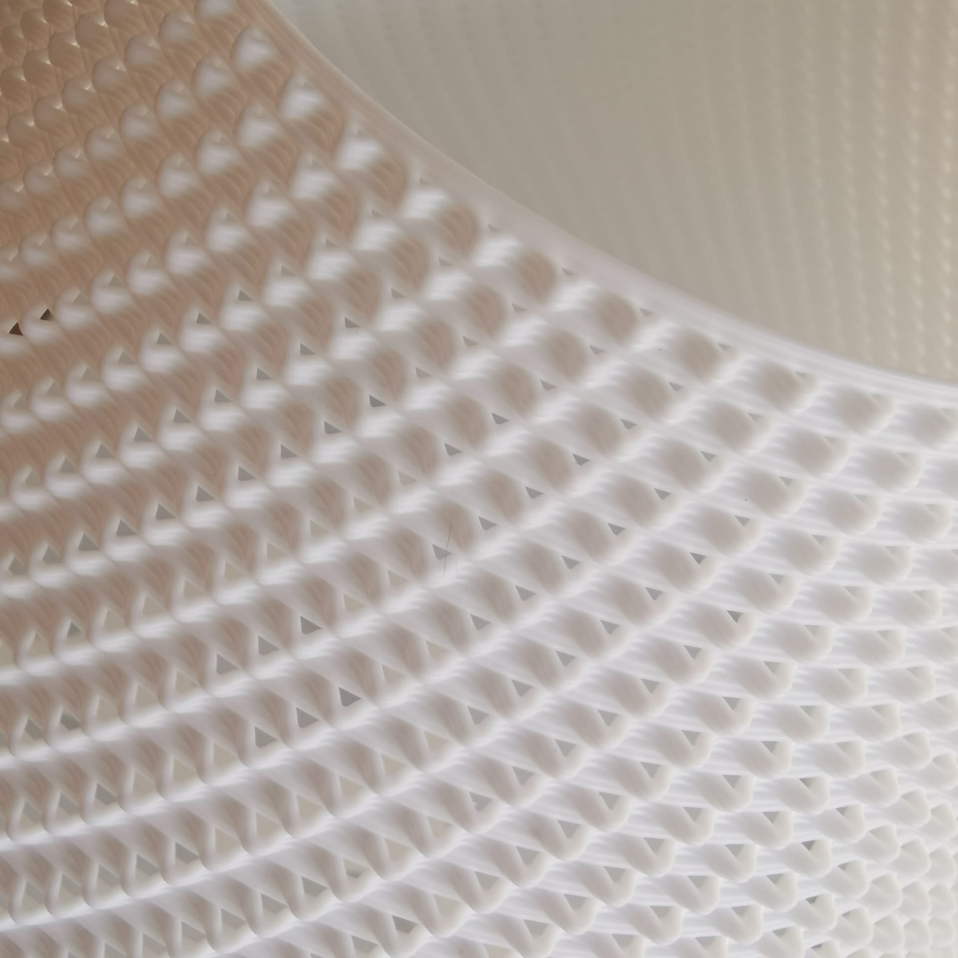 Close-up of a textured white mat with a beige border on a light background