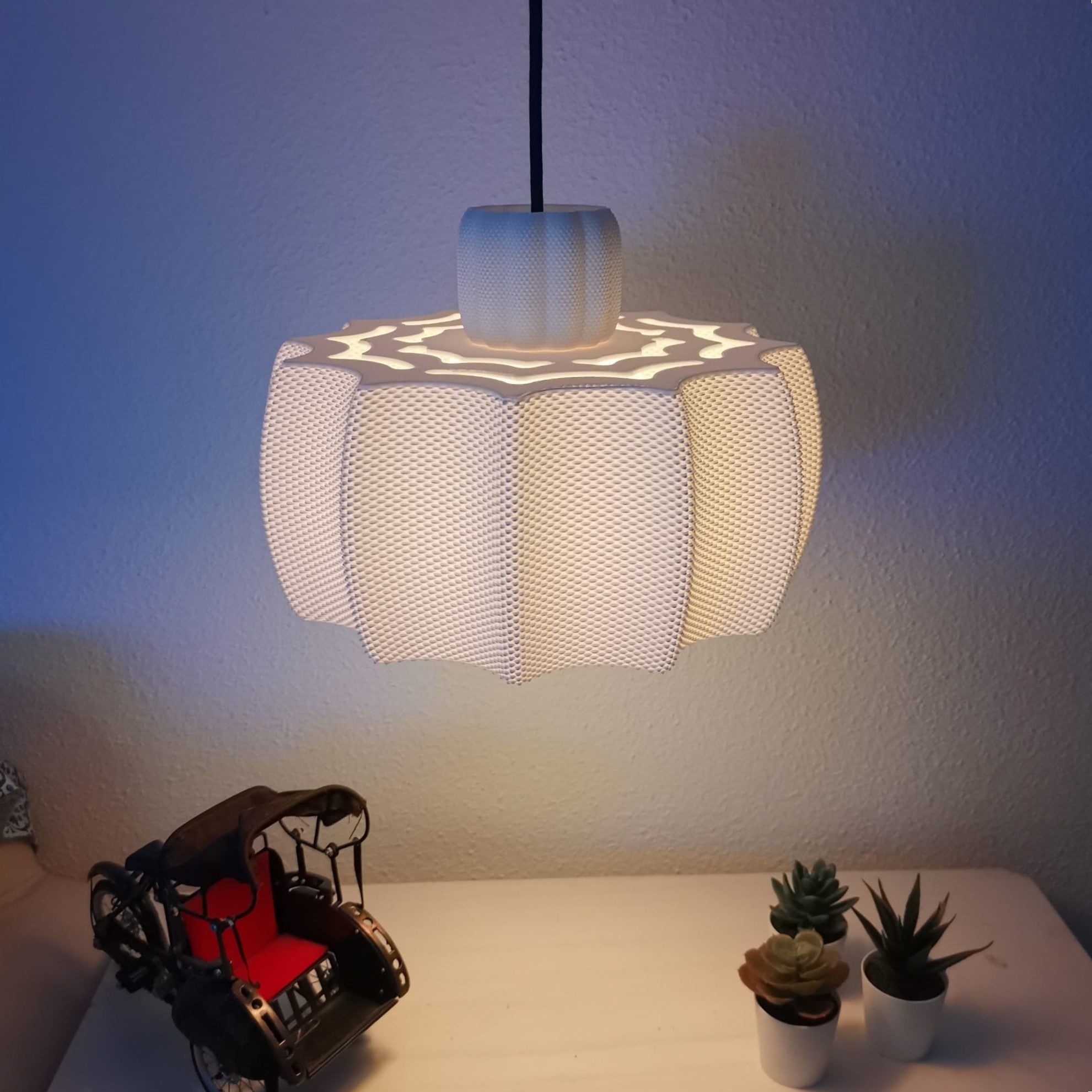 Modern pendant light fixture on a wall with decorative elements below