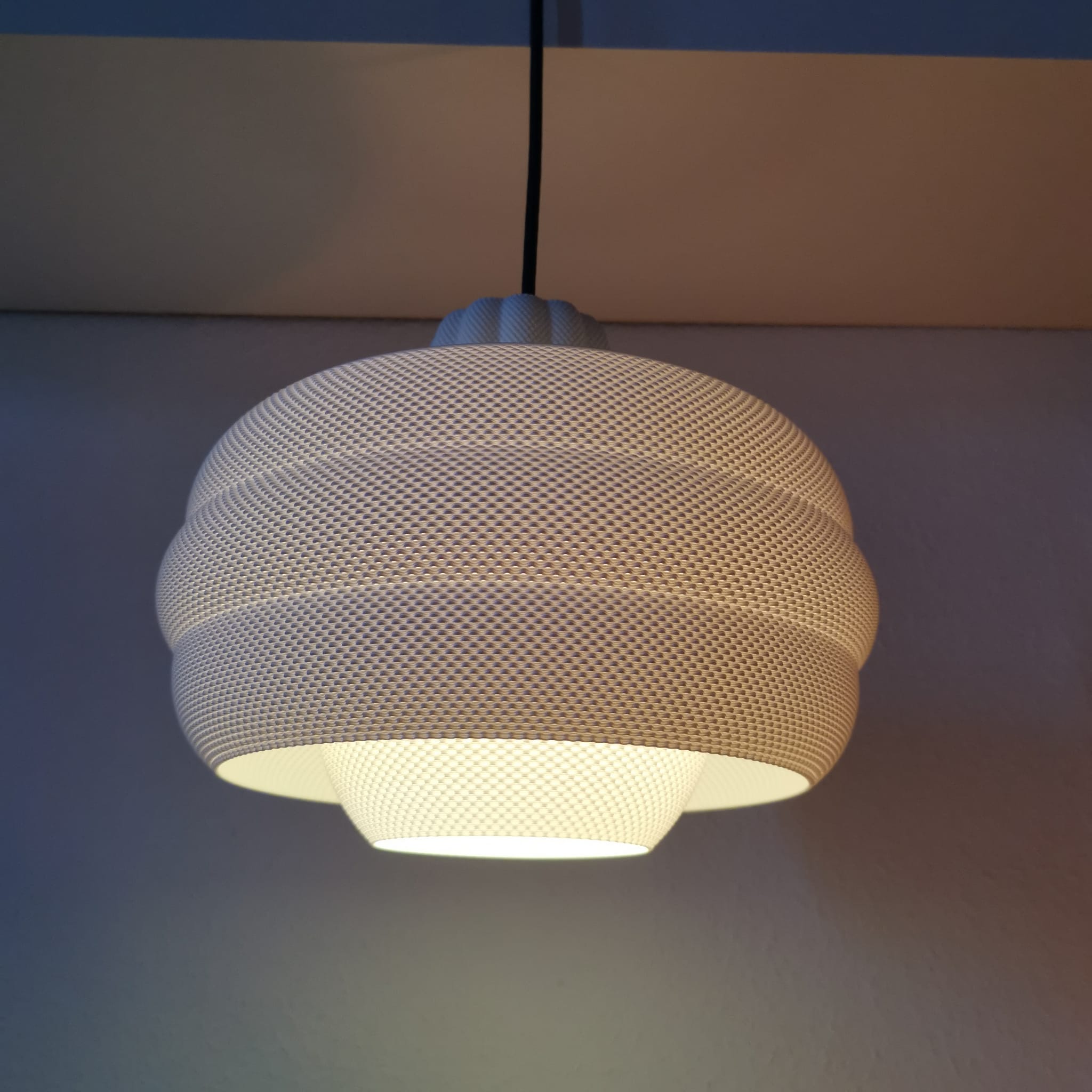 Textured pendant light fixture on a neutral background