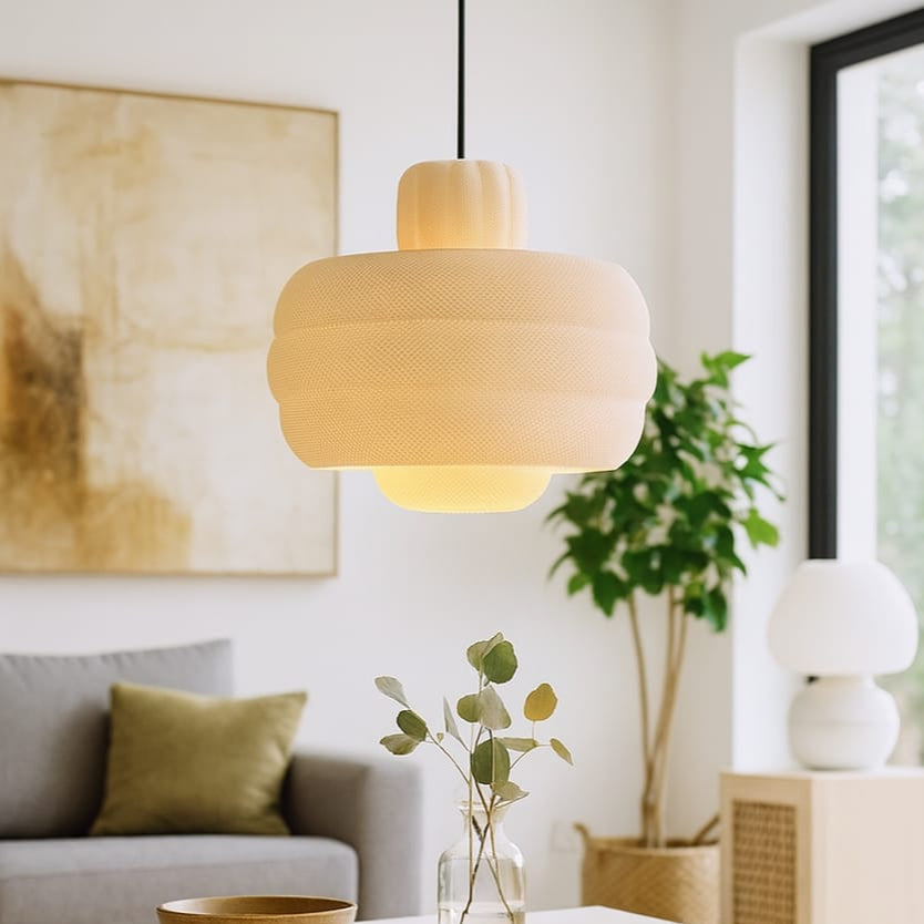 Living room with a pendant light, coffee table, and decorative elements.
