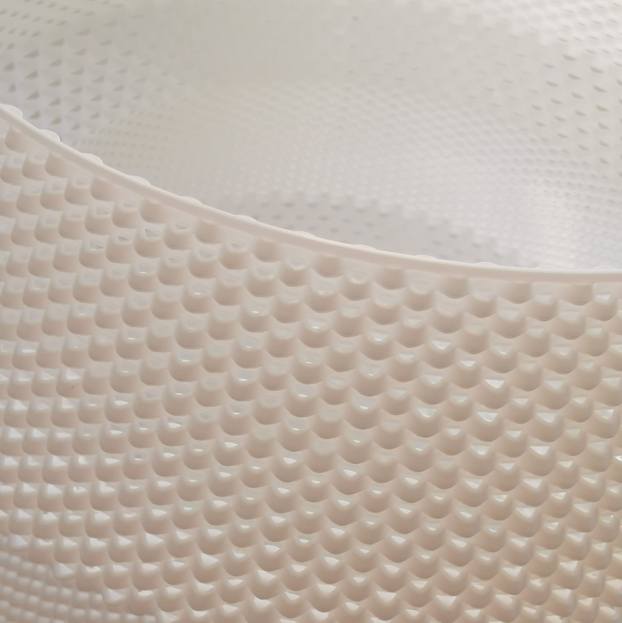 Close-up of a textured beige mat with a white background