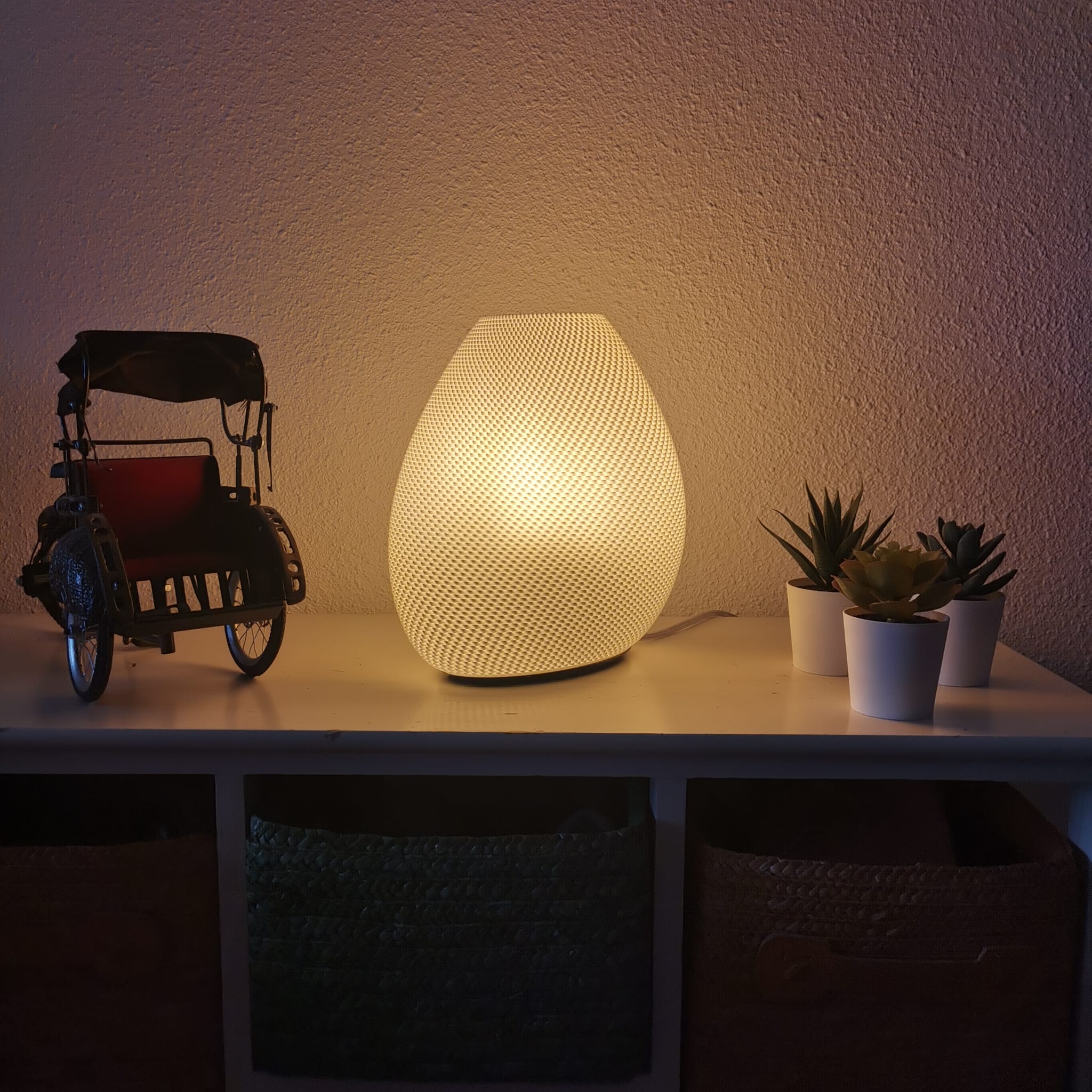 Sculptural bedside lamp with curved design and ambient glow