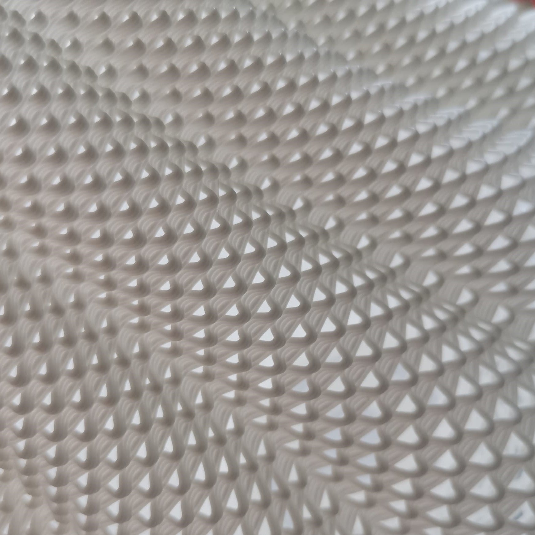 Close-up of a textured beige fabric with a diamond pattern