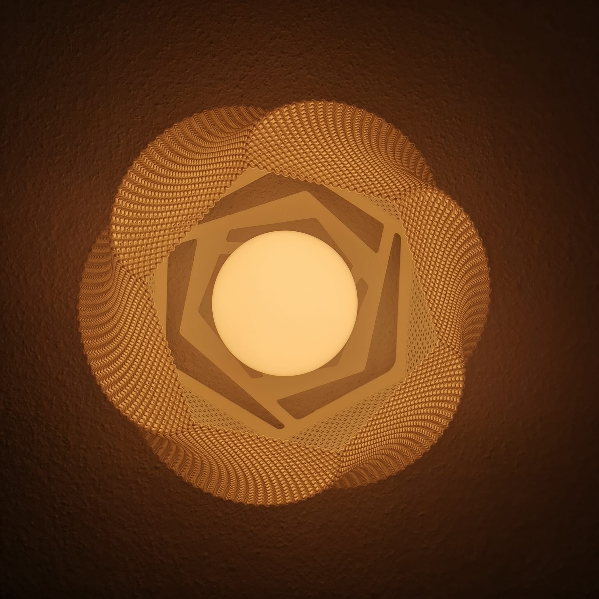 Decorative light fixture with geometric pattern on a brown background