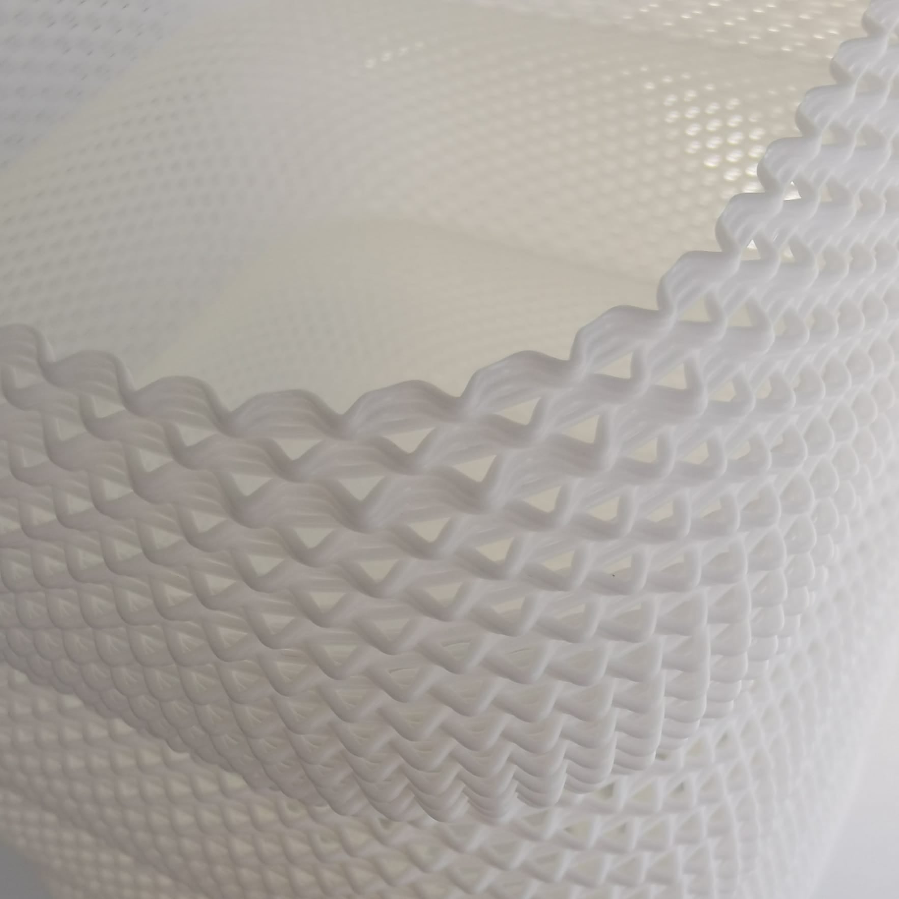 Close-up of textured white fabric with a diamond pattern