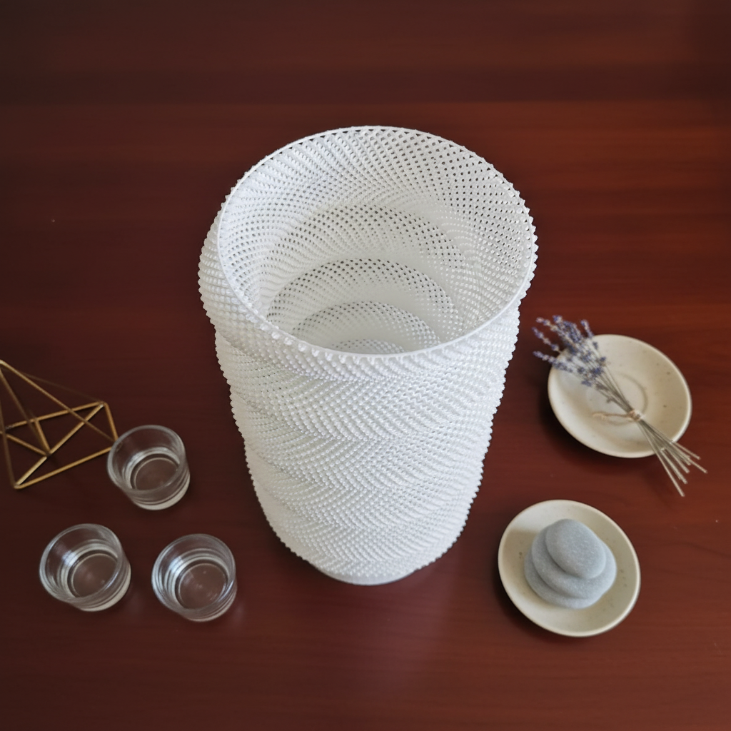 White textured vase on a wooden surface with small decorative items.