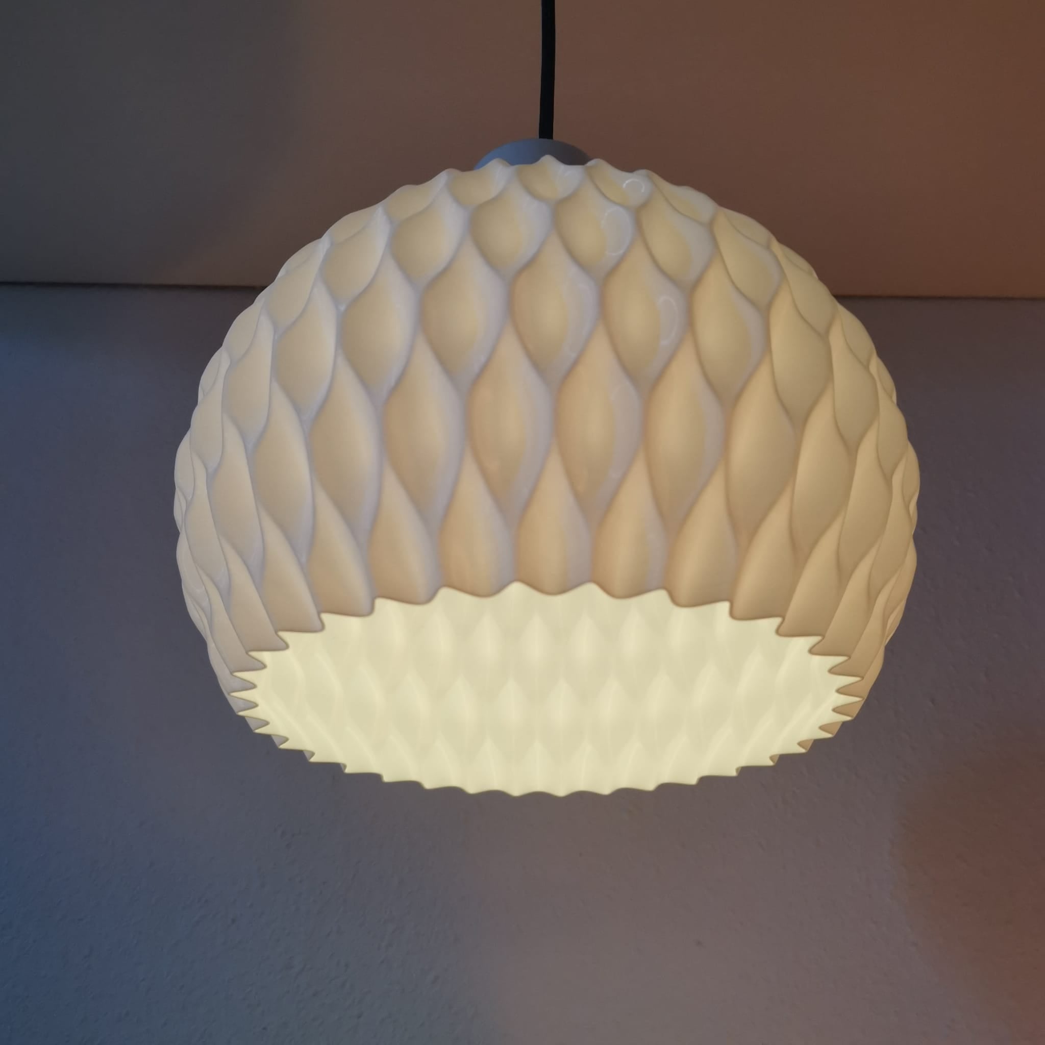 Textured pendant light fixture on a neutral background
