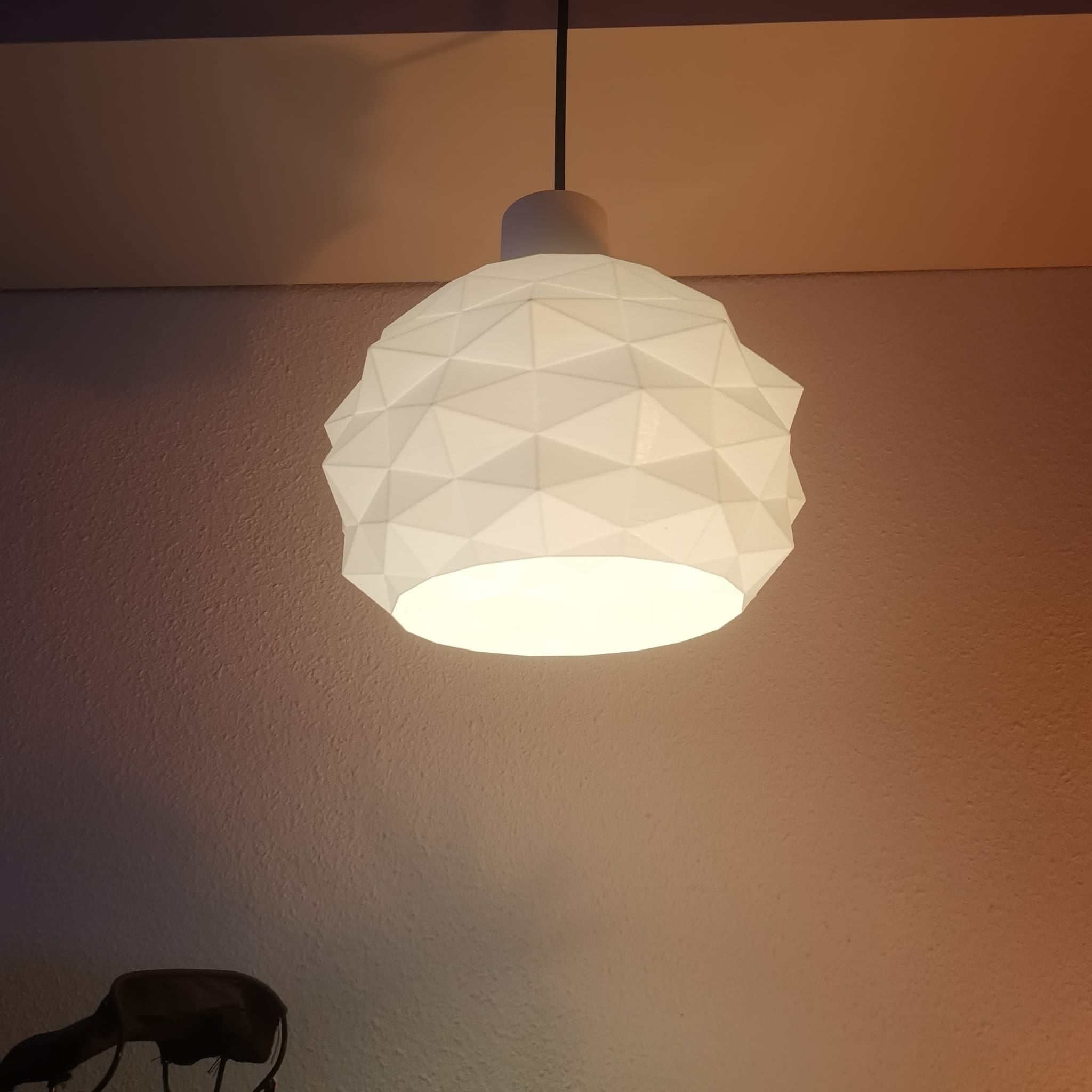 Geometric white pendant light on a neutral wall