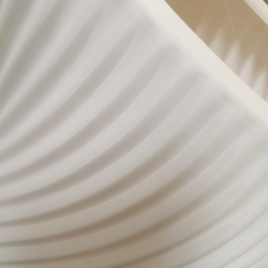 Close-up of ribbed spiral lampshade texture showing fine layered lines and smooth matte finish.