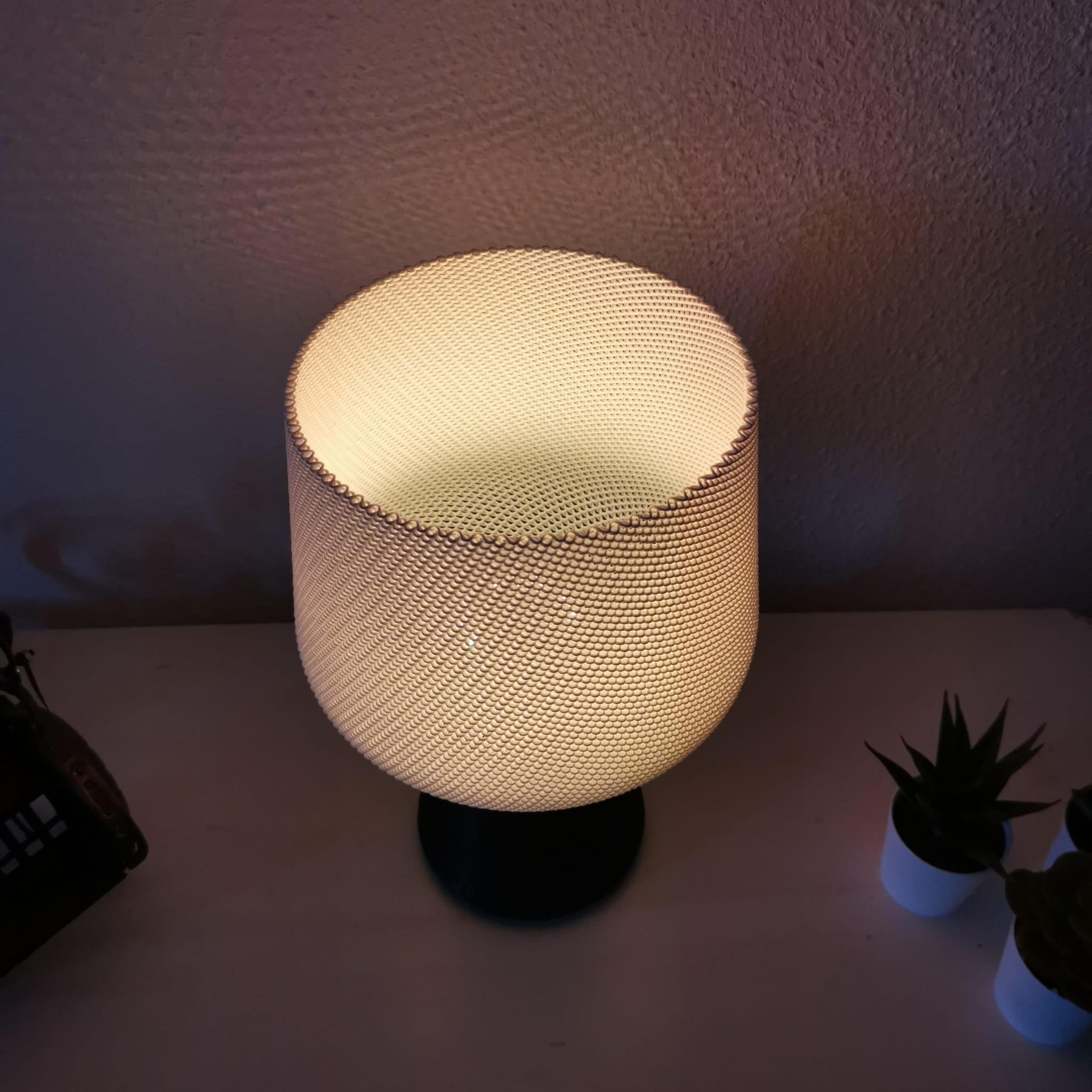 Textured table lamp on a surface with a dark background