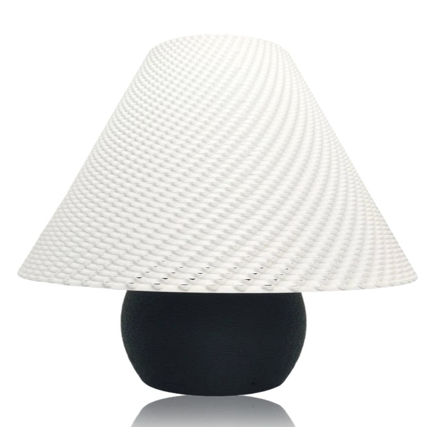 Decorative lamp with a textured white shade and black base on a white background