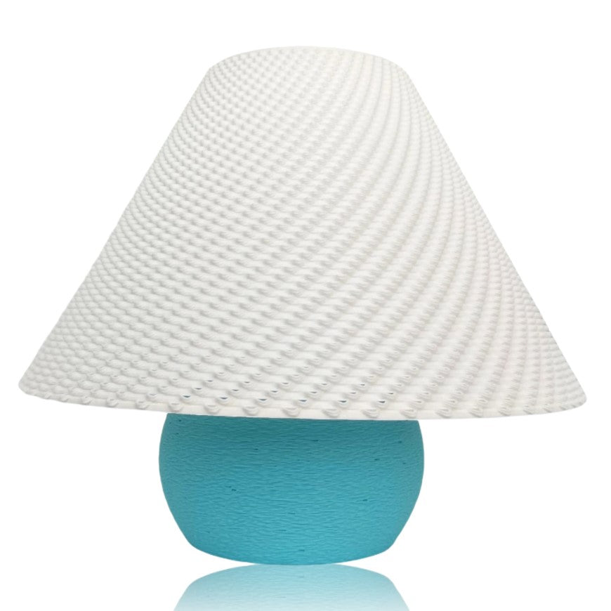 Small lamp with a textured white shade and turquoise base on a white background
