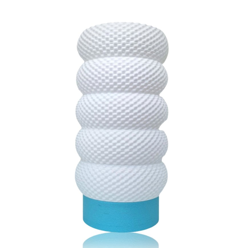 White textured cylindrical table lamp with a blue base on a white background