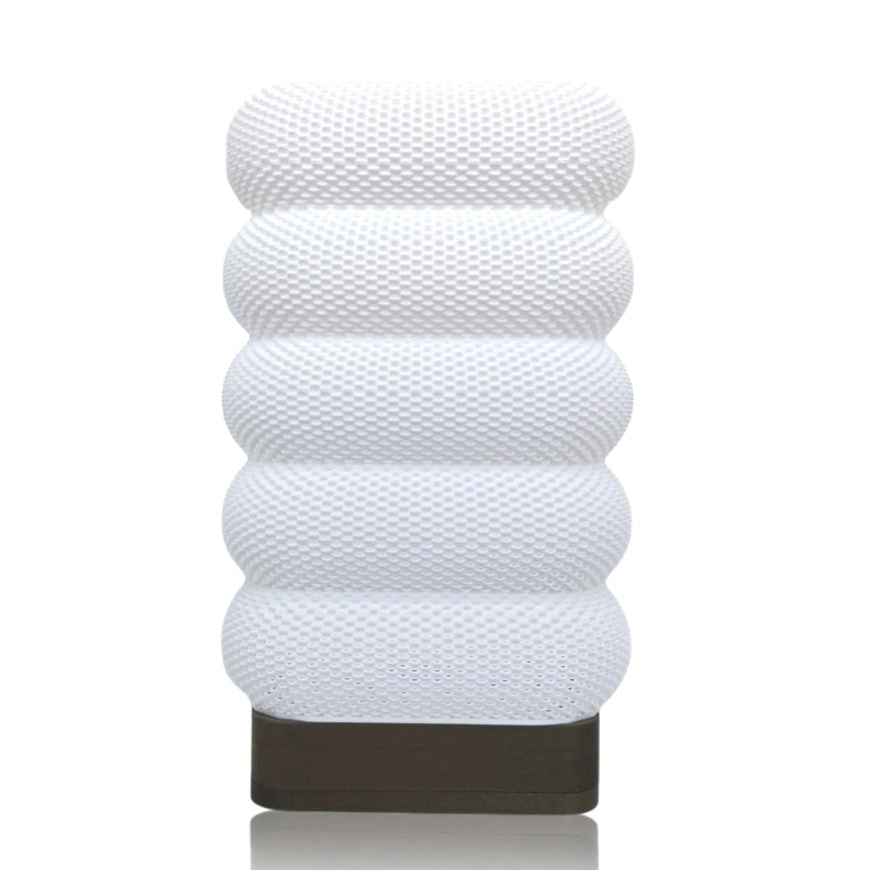 White textured cylindrical table lamp on a white background
