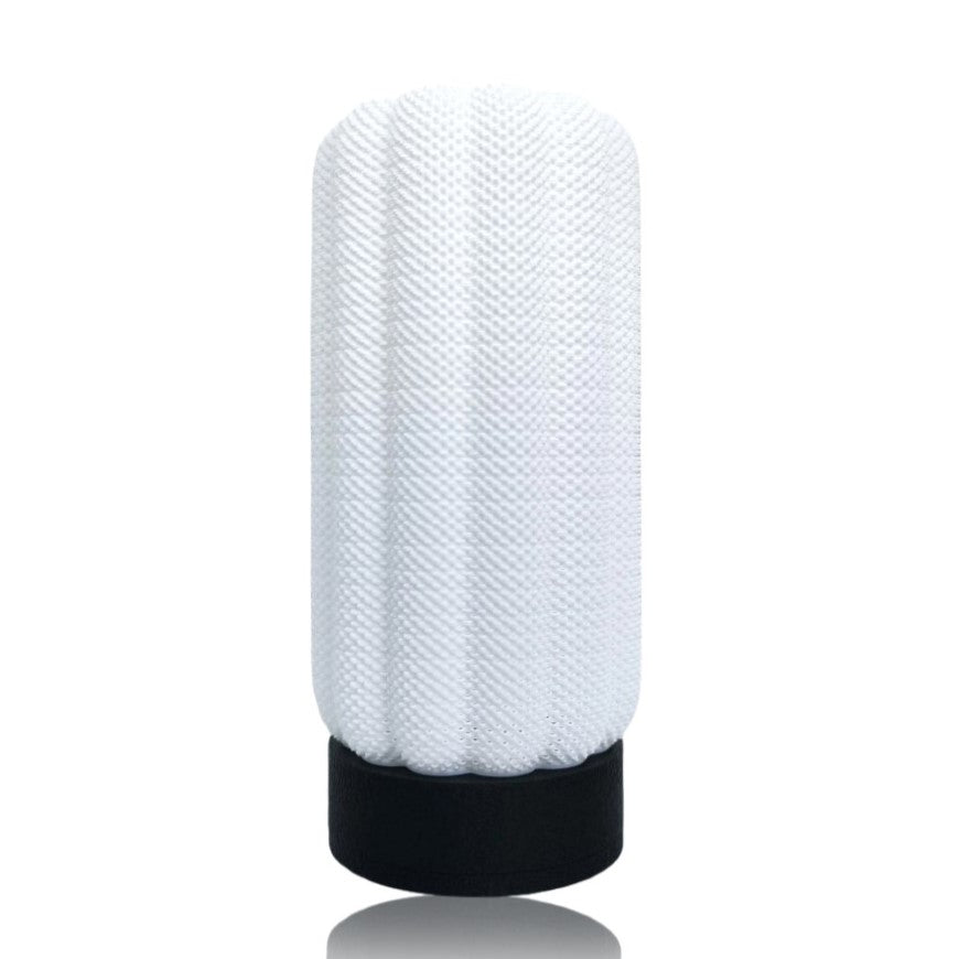 White textured table lamp with black base on a white background