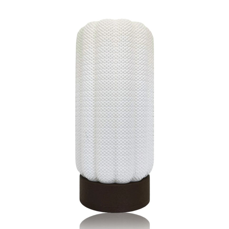Textured white lamp with a brown base on a white background