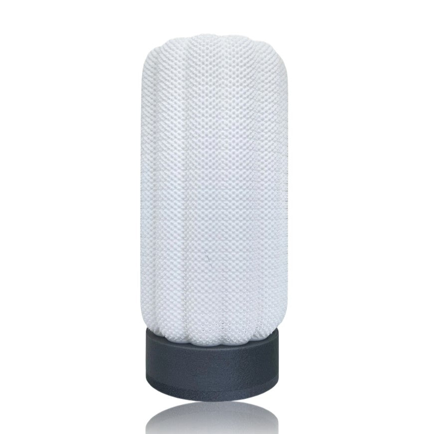 Textured cylindrical table lamp with a silver base on a white background