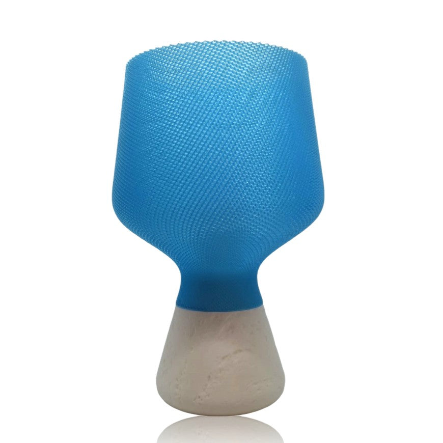 Blue textured table lamp with a base on a white background