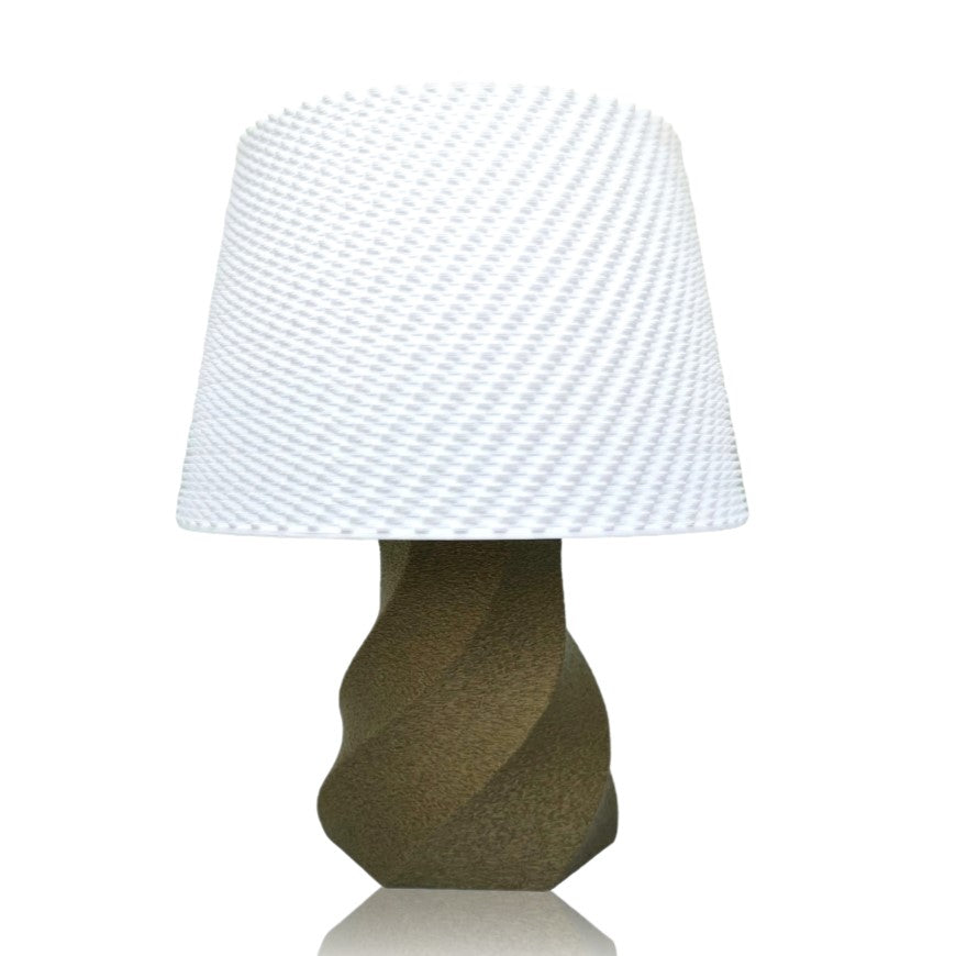 Table lamp with a textured white shade and gold base on a white background