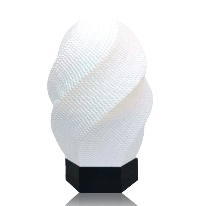Textured white lamp with black base on a white background
