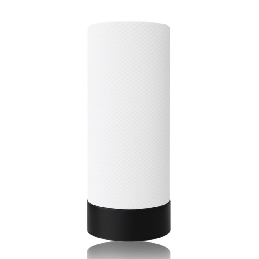 White cylindrical table lamp with black base on a white background