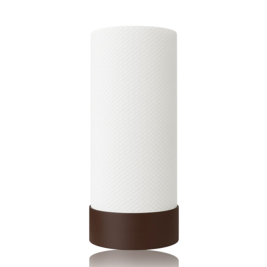White cylindrical table lamp with brown base on a white background