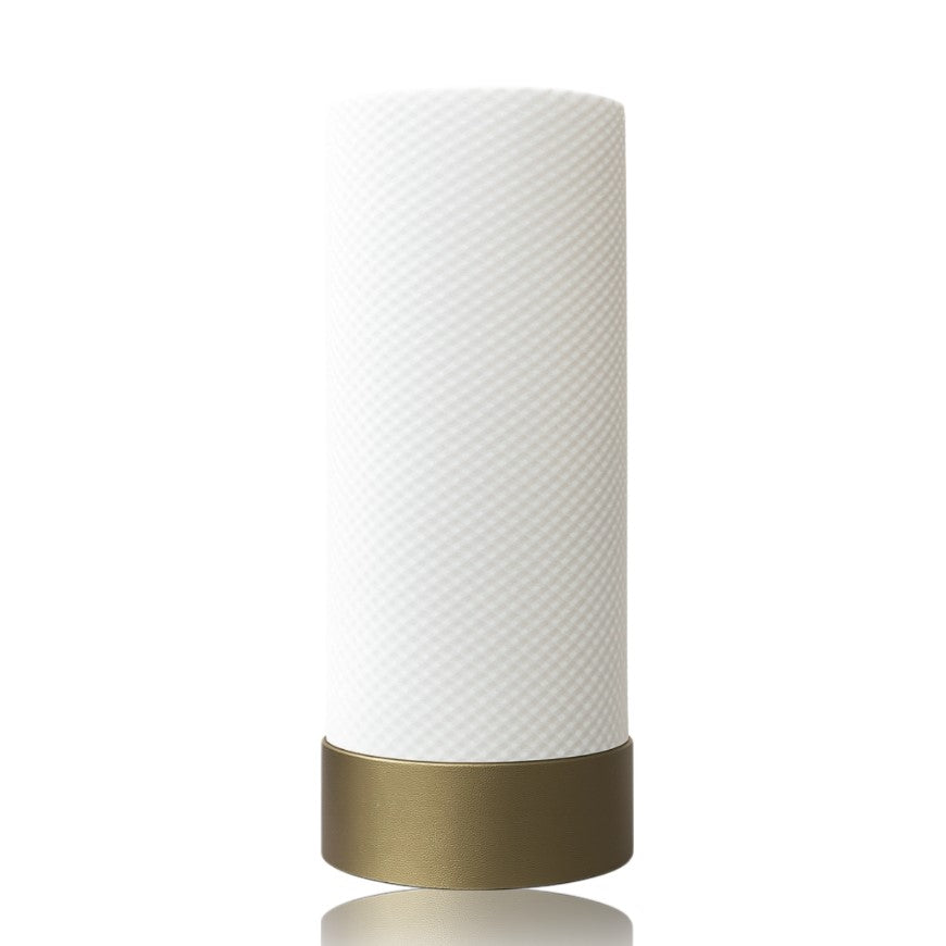 White textured table lamp with a gold base on a white background