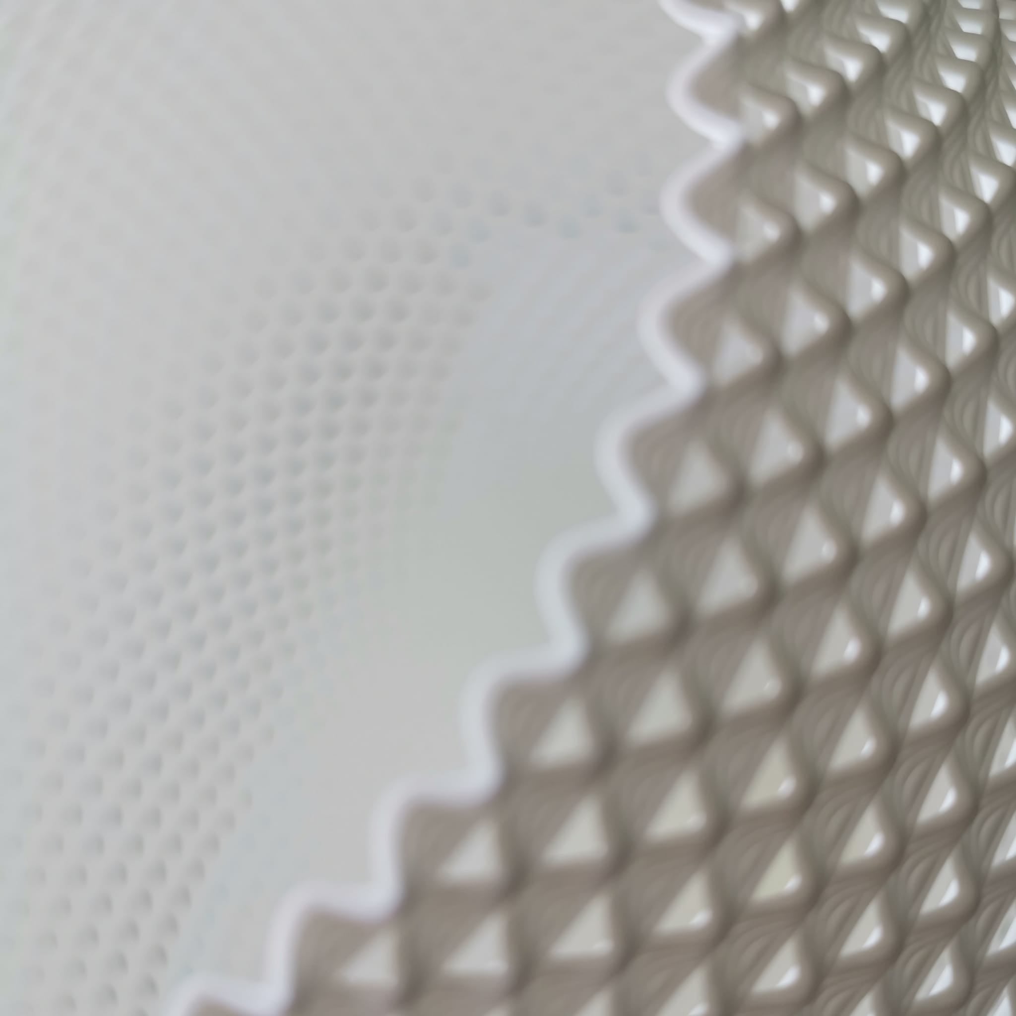 Close-up of textured white pendant lamp with a geometric pattern
