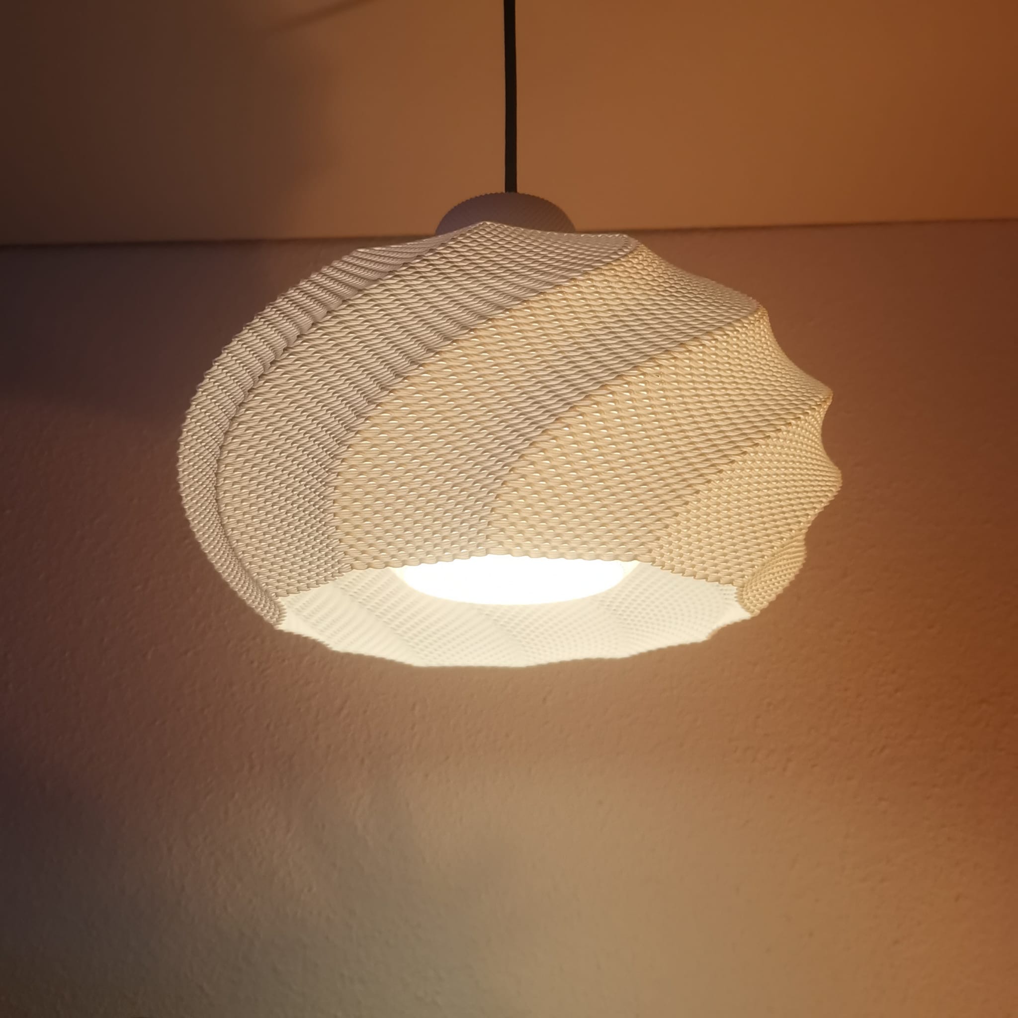 Woven pendant light fixture on a warm-toned wall