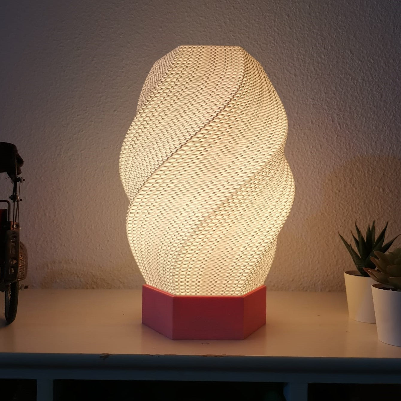 Decorative table lamp with a textured design on a white surface.