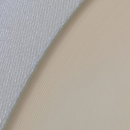 Macro view of the pendant lamp material highlighting the ribbed pattern and matte white finish.