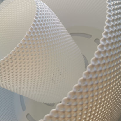 Close-up of a textured white object with a geometric pattern