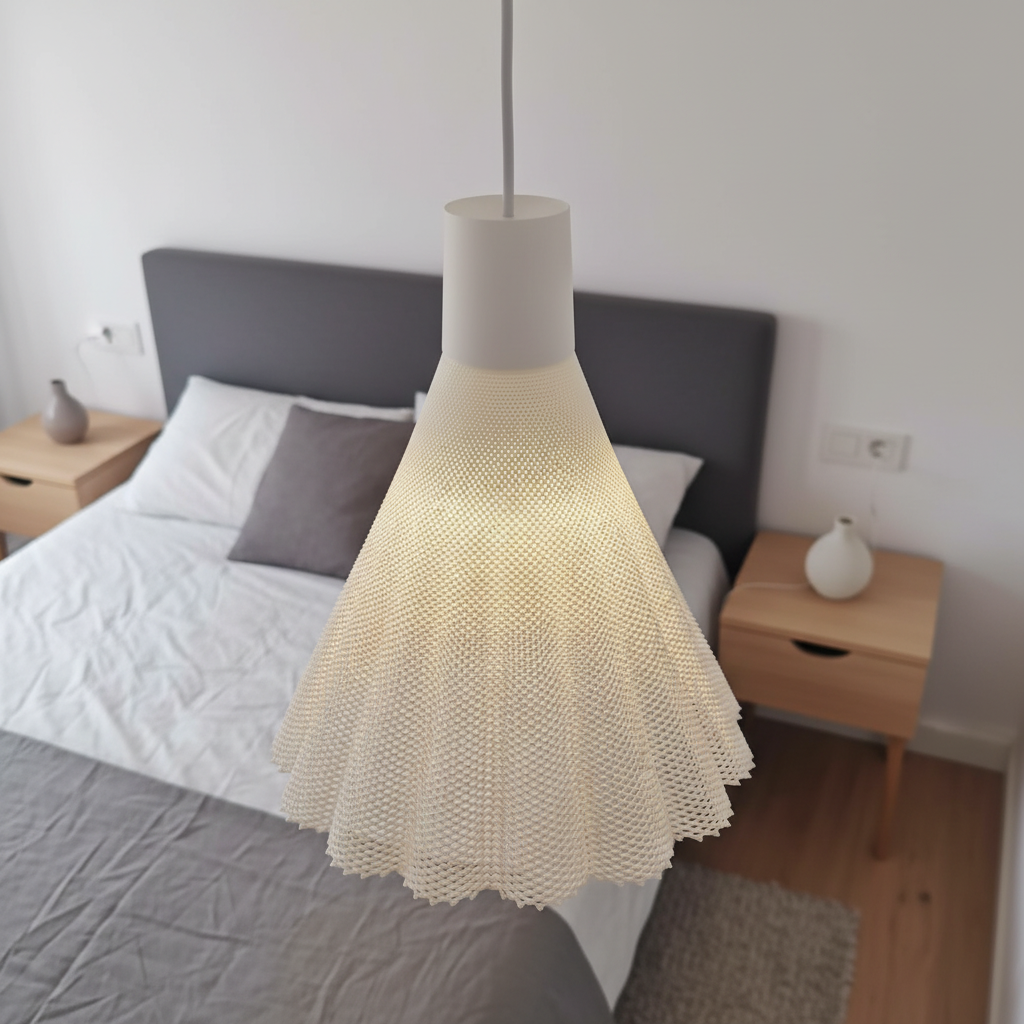 White woven pendant lamp hanging above a bed in a minimalist bedroom with light wood furniture and neutral bedding.