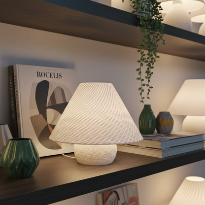 White textured table lamp on a shelf with decorative items