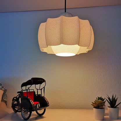 Ceiling light fixture with a decorative shade in a room setting.