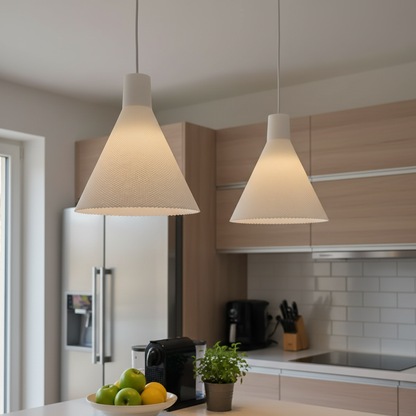 Two white textured cone pendant lights suspended above a kitchen island in a modern kitchen with wood cabinetry.