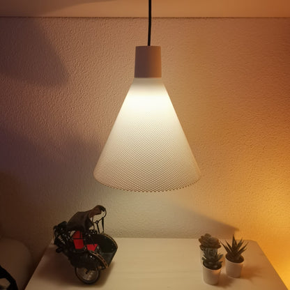 Modern pendant light casting a warm glow on a wall with decorative items below.