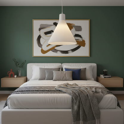 White cone pendant light centered above a modern bed in a bedroom with a dark green accent wall.