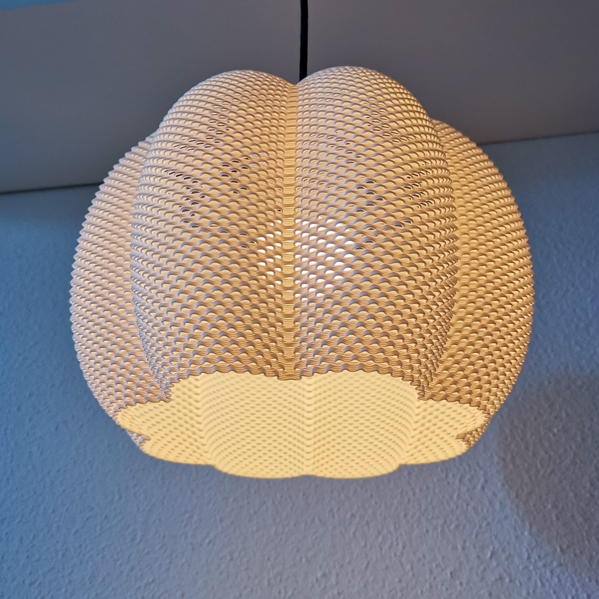 Woven light fixture on a blue wall