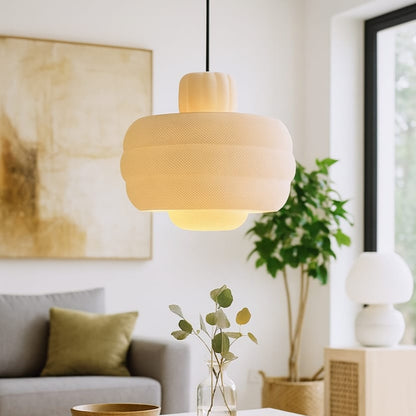 Living room with a pendant light, coffee table, and decorative elements.