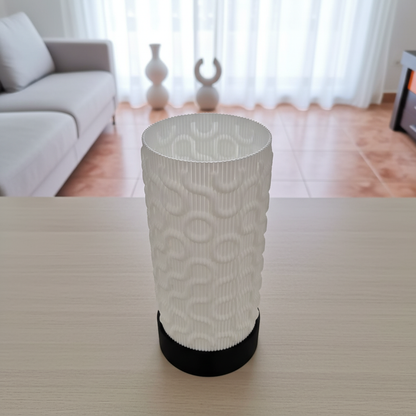 White textured lamp on a table with a blurred living room background