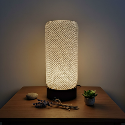 Textured table lamp on a wooden surface with decorative items