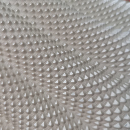 Close-up of a textured beige fabric with a diamond pattern
