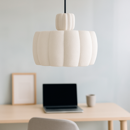 Beige pendant lamp hanging above a desk with a laptop and framed picture.