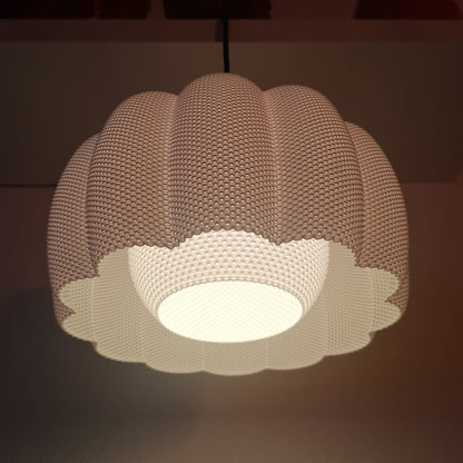 Textured pendant light fixture on a dark background
